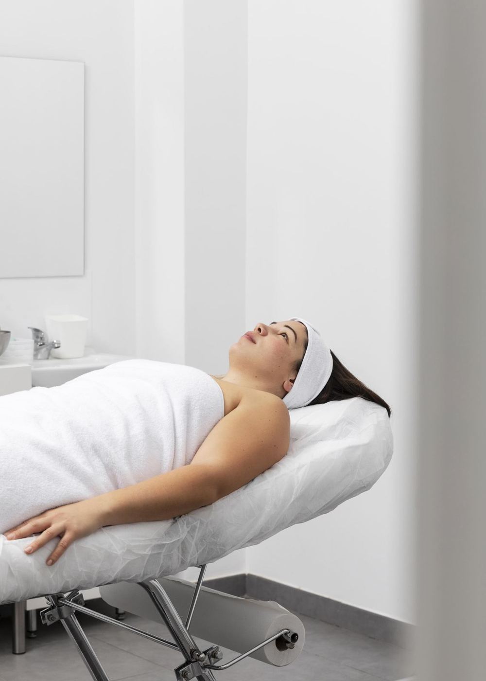 A patient relaxing during a facial treatment